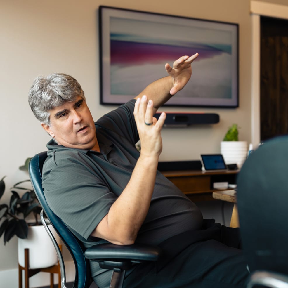 Steve Dowzicky from Competitive Business Solutions explaining a concept during a meeting.