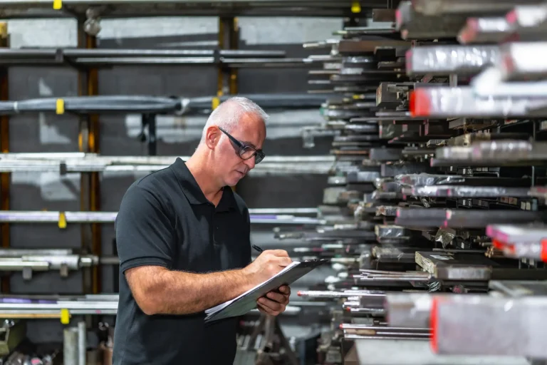 Man Checking Metal Bars While Evaluating Supply Chain Crunch for a Private Equity Review