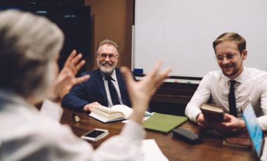 cheerful-colleagues-having-conversation-while-work-2023-11-27-05-01-48-utc (1)