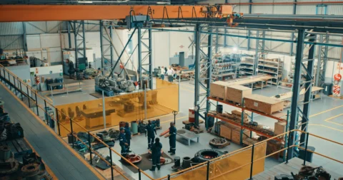 Manufacturing team scoring layout options against clear criteria in a facility layout optimization event.