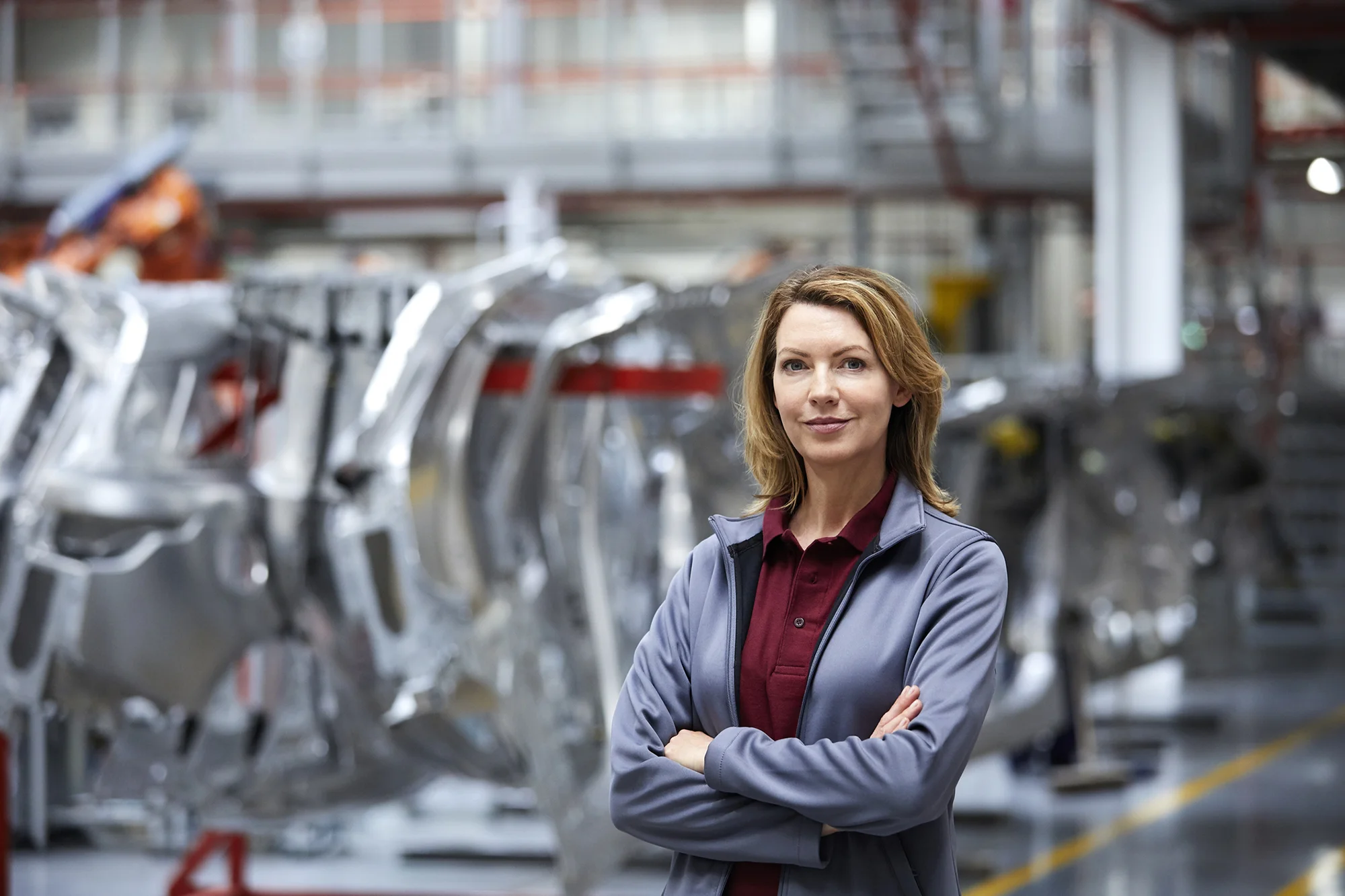 interim leader standing confidently on manufacturing floor