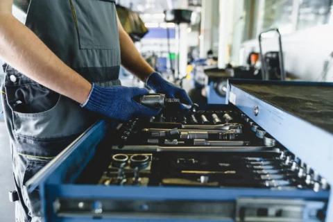 Man sorting tools in factory as part of 5S Sort Deployment