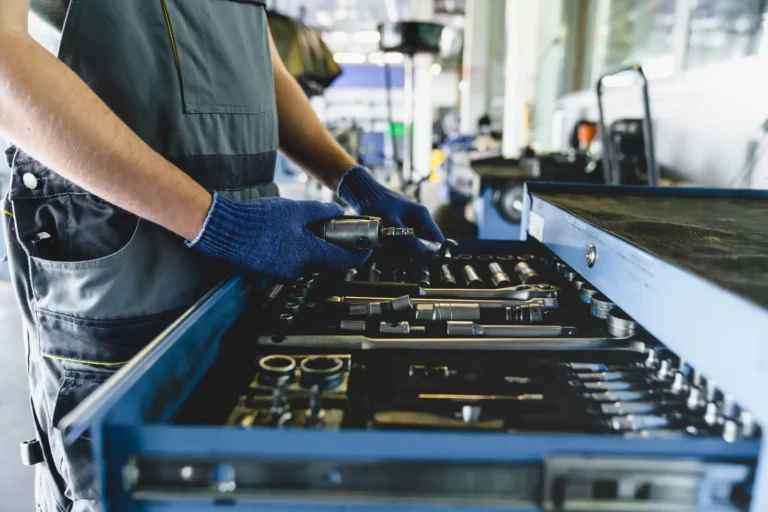 Man sorting tools in factory as part of 5S Sort Deployment