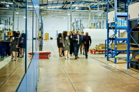 Deal team walking a plant floor during operational due diligence on a manufacturing acquisition.
