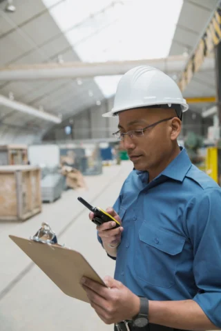 worker-using-walkie-talkie-in-manufacturing-plant